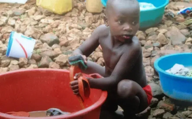 Child cleaning shoes